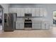 Kitchen with grey cabinetry, granite countertops, and stainless appliances at 1124 Sawgrass Dr, Winter Haven, FL 33884