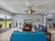 Bright living room with plush carpeting, ceiling fan, and a sliding glass door to the patio at 1124 Sawgrass Dr, Winter Haven, FL 33884