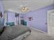 Spacious main bedroom with relaxing lilac walls, soft carpet and decorative accents at 1124 Sawgrass Dr, Winter Haven, FL 33884