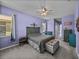 Calming main bedroom featuring soft lilac walls, a cozy bed, and stylish furnishings at 1124 Sawgrass Dr, Winter Haven, FL 33884
