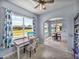 Bright home office with large window offering scenic views and connecting to dining area at 1124 Sawgrass Dr, Winter Haven, FL 33884