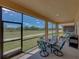 The screened patio has comfortable seating and views of the community green space at 1124 Sawgrass Dr, Winter Haven, FL 33884