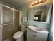 Bathroom features a shower, a white vanity, and a mirrored medicine cabinet for storage at 114 Jana Cir, Auburndale, FL 33823