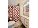 Bathroom features a shower with a curtain, a white vanity, and a mirrored medicine cabinet at 114 Jana Cir, Auburndale, FL 33823