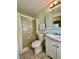 Bathroom features a shower, a white vanity, and a mirrored medicine cabinet for storage at 114 Jana Cir, Auburndale, FL 33823