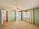 The bedroom showcases a ceiling fan, carpeted floors, and the room gives access to other rooms at 114 Jana Cir, Auburndale, FL 33823