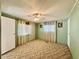 This cozy bedroom features a ceiling fan, carpeted floors, and plenty of natural light from the windows at 114 Jana Cir, Auburndale, FL 33823