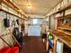 Organized laundry room with washer, dryer, and ample shelving for storage and cleaning supplies at 114 Jana Cir, Auburndale, FL 33823