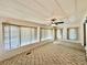 Spacious living room featuring multiple windows and a ceiling fan at 114 Jana Cir, Auburndale, FL 33823