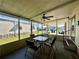 This cozy covered porch offers an outdoor seating area with a ceiling fan for added comfort at 114 Jana Cir, Auburndale, FL 33823