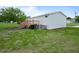 Backyard view featuring a wooden deck and ample space for outdoor activities at 1302 Windsong Dr, Lakeland, FL 33811