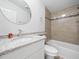 Modern bathroom featuring granite countertops and a tiled shower at 1302 Windsong Dr, Lakeland, FL 33811