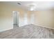 Spacious bedroom with ceiling fan, neutral walls, and stylish flooring at 1302 Windsong Dr, Lakeland, FL 33811