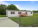 Charming single-story home featuring a well-maintained lawn and inviting front porch at 1302 Windsong Dr, Lakeland, FL 33811