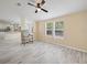 Open-concept living room with modern flooring and natural light flowing into the kitchen at 1302 Windsong Dr, Lakeland, FL 33811