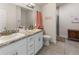 Bathroom featuring double sinks, granite countertops, vanity and tiled floors at 135 Krenson Bay Loop, Winter Haven, FL 33881