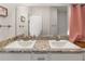 Bathroom featuring double sinks, granite countertops, vanity and brushed silver fixtures at 135 Krenson Bay Loop, Winter Haven, FL 33881