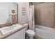 Bathroom featuring a single vanity, a shower/tub combo, and tiled walls at 135 Krenson Bay Loop, Winter Haven, FL 33881