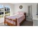 Cozy bedroom with a wood frame bed, natural lighting, and neutral carpet at 135 Krenson Bay Loop, Winter Haven, FL 33881