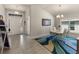 Bright dining room with modern lighting, elegant white table set, and tiled flooring at 135 Krenson Bay Loop, Winter Haven, FL 33881