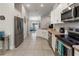 Bright kitchen featuring stainless steel appliances, white cabinetry, and tile flooring at 135 Krenson Bay Loop, Winter Haven, FL 33881