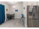 Kitchen and eat-in nook featuring stainless steel refrigerator and modern lighting at 135 Krenson Bay Loop, Winter Haven, FL 33881