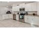 Modern kitchen with white cabinetry, stainless steel appliances, and ample counter space at 135 Krenson Bay Loop, Winter Haven, FL 33881
