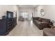 Spacious living room with tiled floors, comfortable seating, and ample natural light at 135 Krenson Bay Loop, Winter Haven, FL 33881