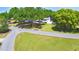 An aerial view showcases the home's location on a corner lot surrounded by green spaces and mature trees at 151 Lake Ring Dr, Winter Haven, FL 33884