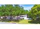 An elevated angle showcases the home's location surrounded by green spaces and mature trees at 151 Lake Ring Dr, Winter Haven, FL 33884