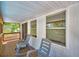Inviting back porch with rocking chairs and a view of lush greenery and privacy at 151 Lake Ring Dr, Winter Haven, FL 33884