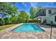Backyard view of the home featuring a sparkling in-ground swimming pool, green grass, and screened porch at 151 Lake Ring Dr, Winter Haven, FL 33884