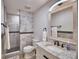 Bathroom featuring a marble vanity, framed mirror, and tiled shower with glass doors at 151 Lake Ring Dr, Winter Haven, FL 33884