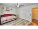Bedroom featuring wood-look floors, a closet, and a trundle bed at 151 Lake Ring Dr, Winter Haven, FL 33884