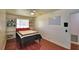 Cozy bedroom featuring a ceiling fan, built-in shelves, and warm hardwood floors at 151 Lake Ring Dr, Winter Haven, FL 33884