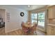 Charming breakfast nook featuring a round wooden table and a large window with a pleasant view at 151 Lake Ring Dr, Winter Haven, FL 33884