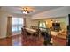 Dining area with a large wooden table, seating for eight, and views of the pool through a nearby window at 151 Lake Ring Dr, Winter Haven, FL 33884