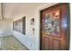 Charming front door with glass panel and white brick exterior, enhancing curb appeal and natural light at 151 Lake Ring Dr, Winter Haven, FL 33884