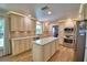 Well-lit kitchen with custom cabinets, stainless steel appliances, and center island with marble countertops at 151 Lake Ring Dr, Winter Haven, FL 33884