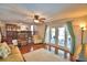 Sunlit living room featuring hardwood floors, ceiling fan, and French doors leading to the backyard patio at 151 Lake Ring Dr, Winter Haven, FL 33884