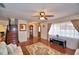 Cozy living room featuring hardwood floors, a ceiling fan, staircase, and a large window offering plenty of natural light at 151 Lake Ring Dr, Winter Haven, FL 33884