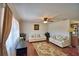 Bright living room with hardwood floors, neutral furniture, a ceiling fan, and well-placed decor at 151 Lake Ring Dr, Winter Haven, FL 33884