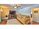 Cozy living room showcases a painted brick wall, hardwood floors, and comfortable seating arrangement at 151 Lake Ring Dr, Winter Haven, FL 33884