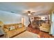Comfortable living room with ceiling fan, hardwood floors, and access to the dining room at 151 Lake Ring Dr, Winter Haven, FL 33884