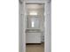Bathroom with a large mirror, a single sink vanity, and tile flooring at 1550 11Th Ne St # G6, Winter Haven, FL 33881