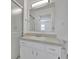 Bathroom featuring a shower over bath, a single sink vanity, and a large mirror at 1550 11Th Ne St # G6, Winter Haven, FL 33881