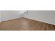 Bedroom with wood-look flooring, white walls, and a window with blinds at 1550 11Th Ne St # G6, Winter Haven, FL 33881