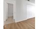 Bedroom leading to bathroom, showing wood-look flooring, closet, and doorway at 1550 11Th Ne St # G6, Winter Haven, FL 33881