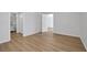 Bedroom view featuring wood-look flooring, white walls, and two doorways at 1550 11Th Ne St # G6, Winter Haven, FL 33881