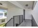 A second story unit exterior with white brick and black painted rails and door at 1550 11Th Ne St # G6, Winter Haven, FL 33881